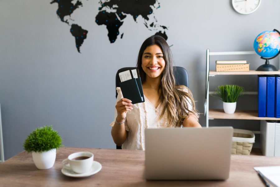 i-am-here-help-you-with-your-booking-travel-questions-female-sales-agent-holding-plane-tickets-while-smiling-making-eye-contact-travel-agency